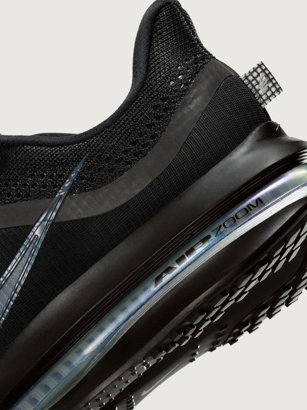 Black sneaker with air cushion sole on a light gray background