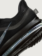 Black sneaker with air cushion sole on a light gray background