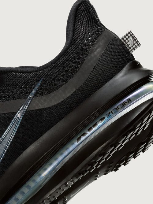 Black sneaker with air cushion sole on a light gray background