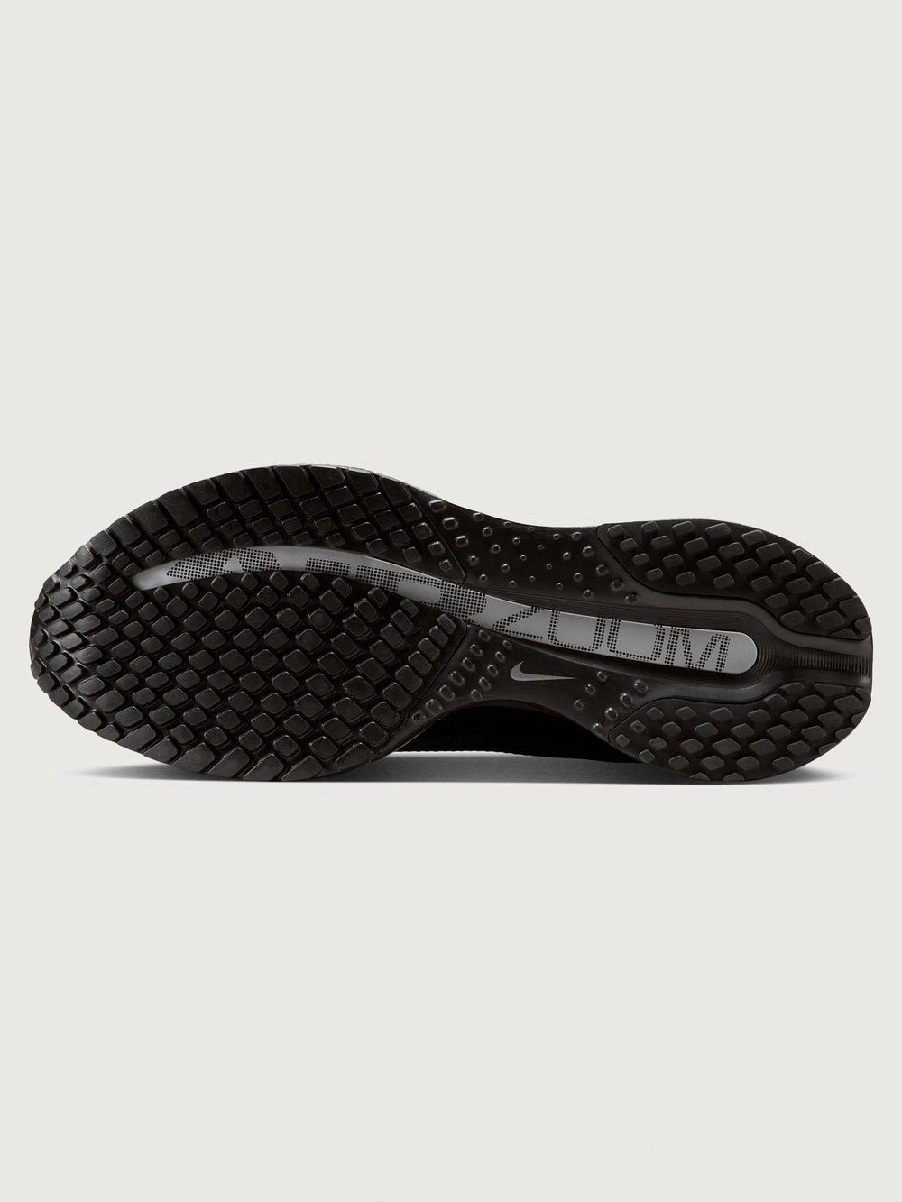 Black Nike shoe sole on a light gray background