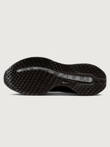 Black Nike shoe sole on a light gray background