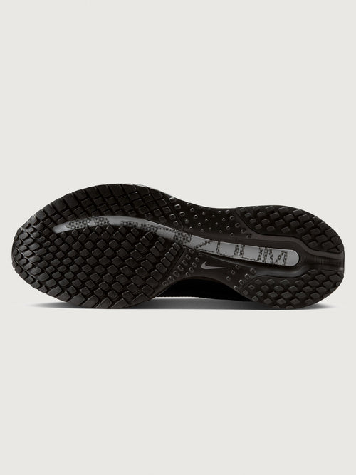 Black Nike shoe sole on a light gray background