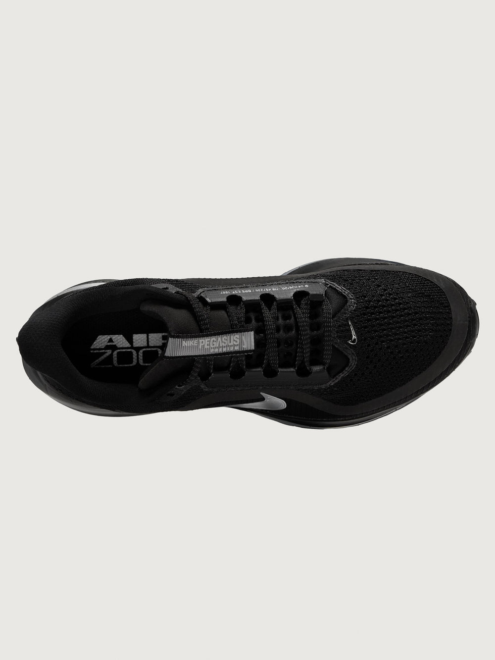 Black running shoe with 'Air Zoom' and 'Nike' branding on a light gray background