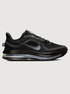 Black sneaker with a visible air cushion on a light gray background
