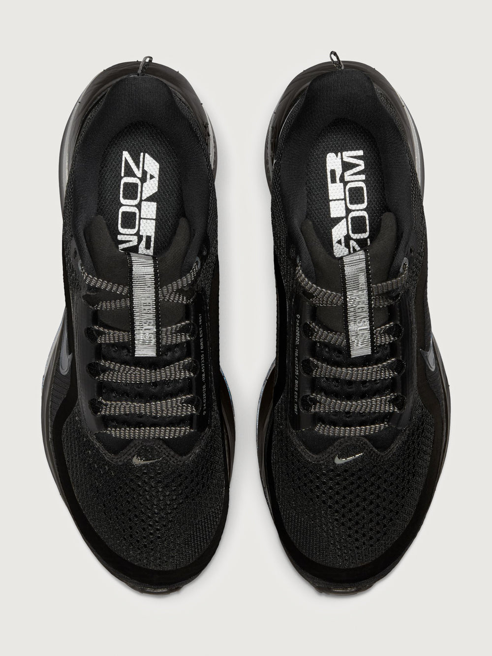 Black running shoes with 'Air Zoom' branding on a white background