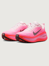 Pink running shoe with black Nike logo on a white background