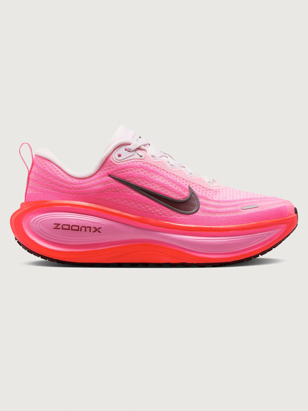 Pink running shoe with black Nike logo on a white background