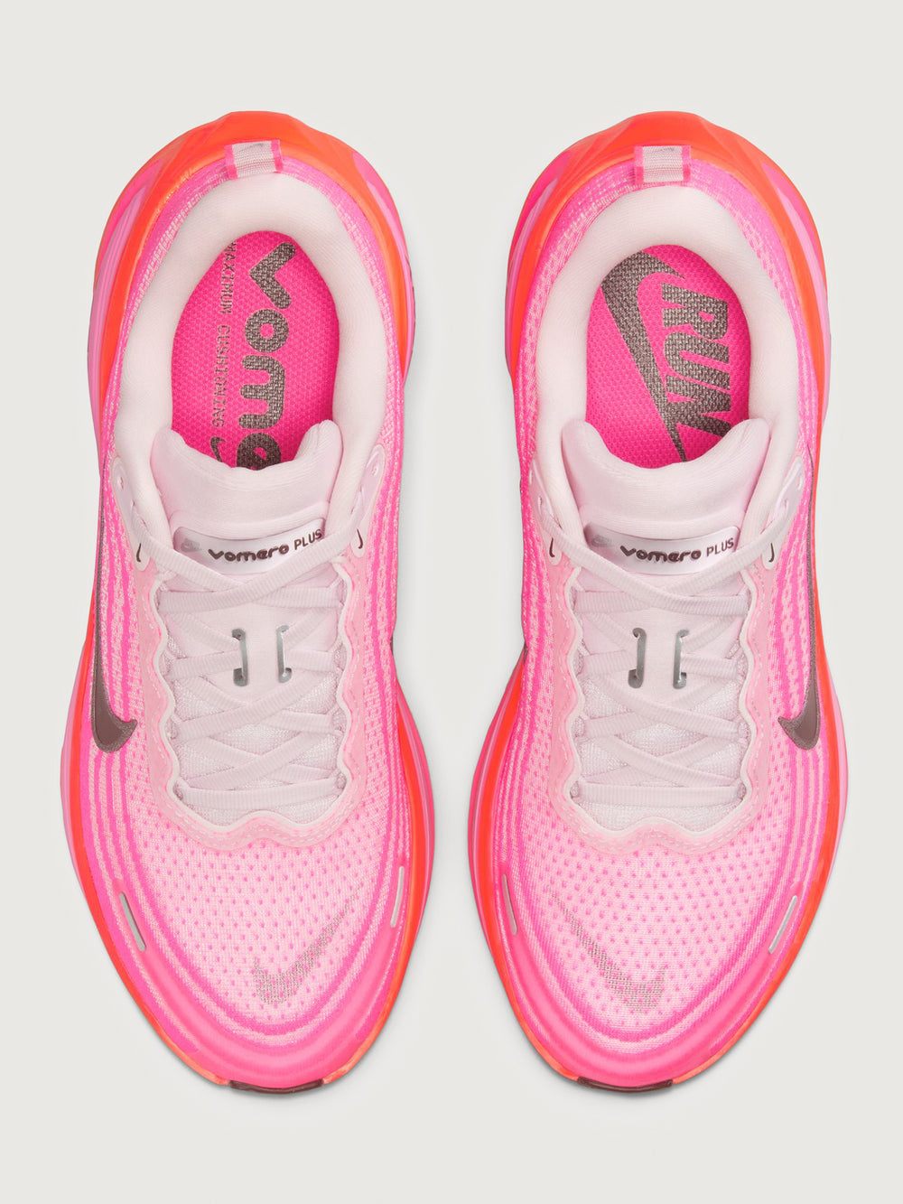 Pink running shoe with black Nike logo on a white background