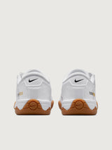 White Nike sneaker with brown sole on a white background