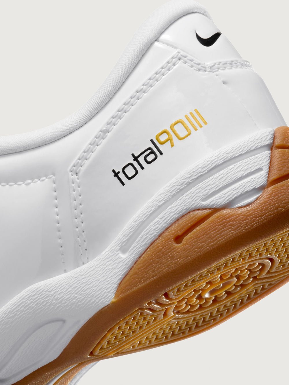 White Nike sneaker with brown sole on a white background