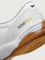White Nike sneaker with brown sole on a white background