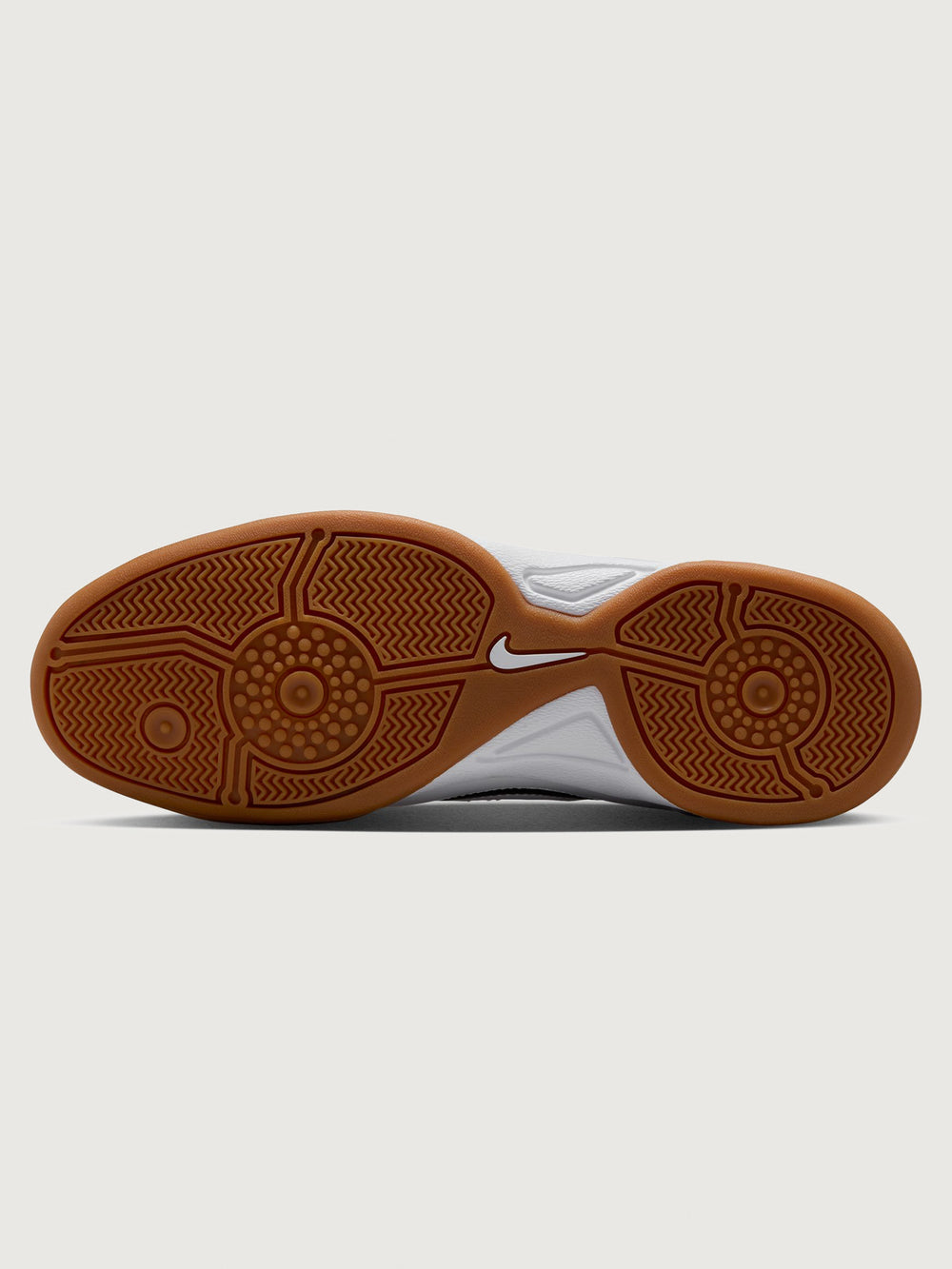 White Nike sneaker with brown sole on a white background