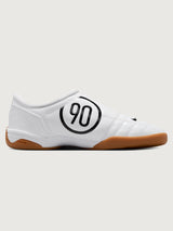 White Nike sneaker with brown sole on a white background