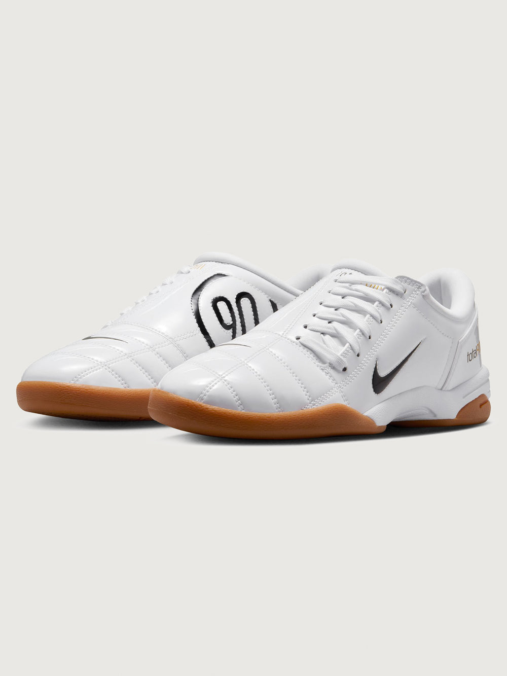 White Nike sneaker with brown sole on a white background