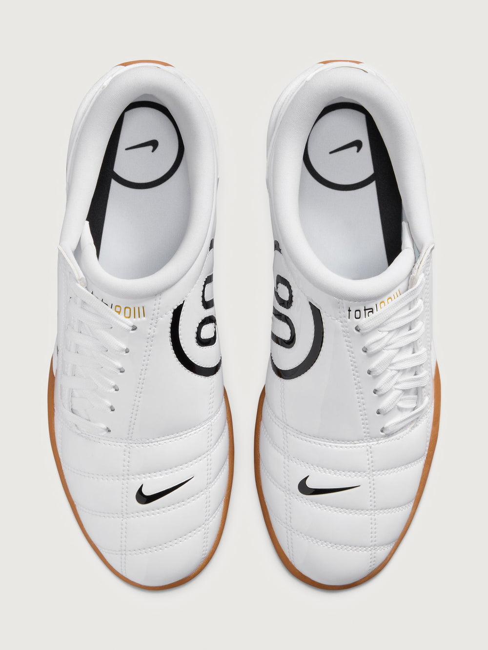 White Nike sneaker with brown sole on a white background