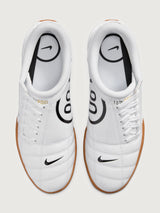 White Nike sneaker with brown sole on a white background