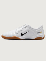 White Nike sneaker with brown sole on a white background