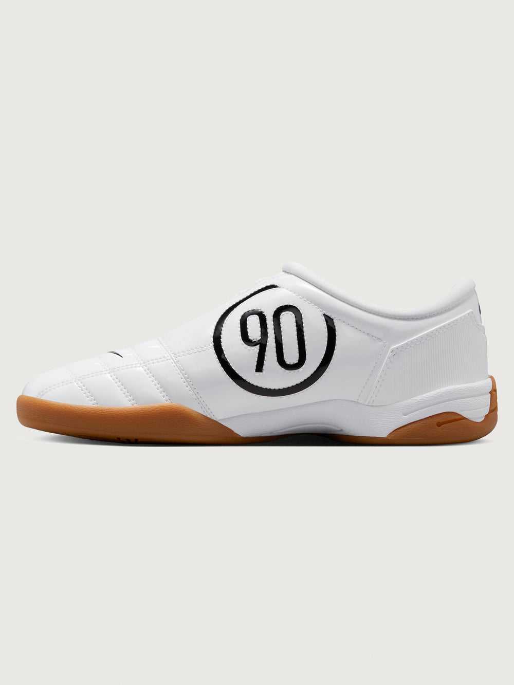 White Nike sneaker with brown sole on a white background