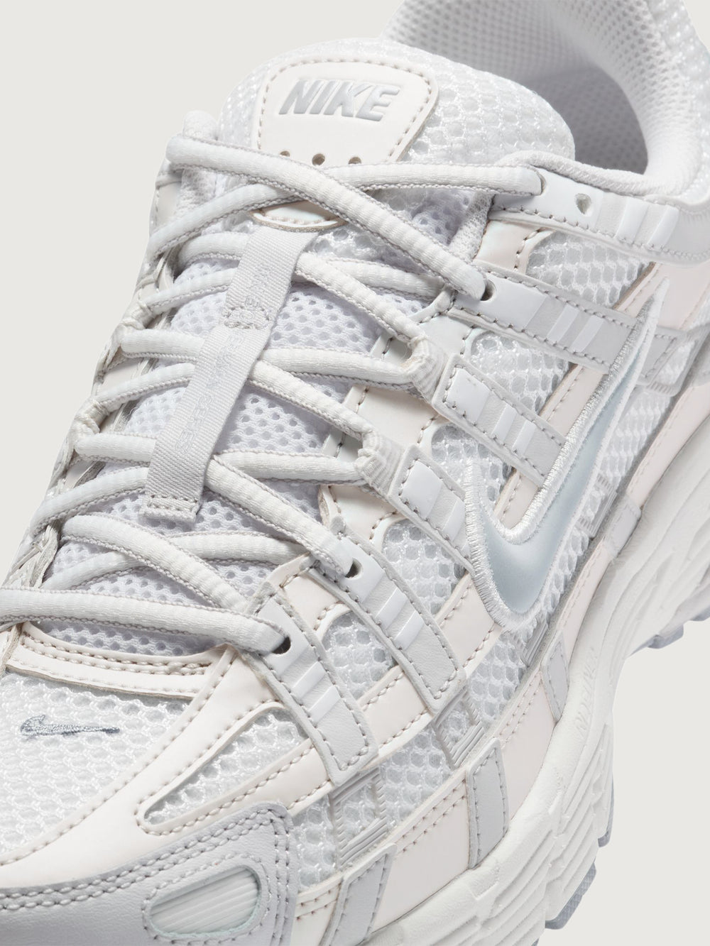 Nike P-6000 SE in Summit White and Wolf Grey, close-up lace and mesh detail.