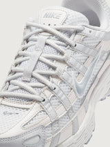 Nike P-6000 SE in Summit White and Wolf Grey, close-up lace and mesh detail.