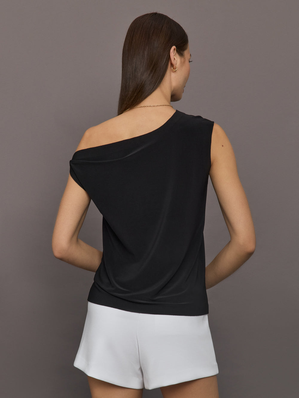 Model wears black short-sleeve top with a drop shoulder design.

