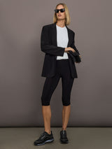 Model is wearing Sleeveless Twist Top in Snow White, full body styled look.