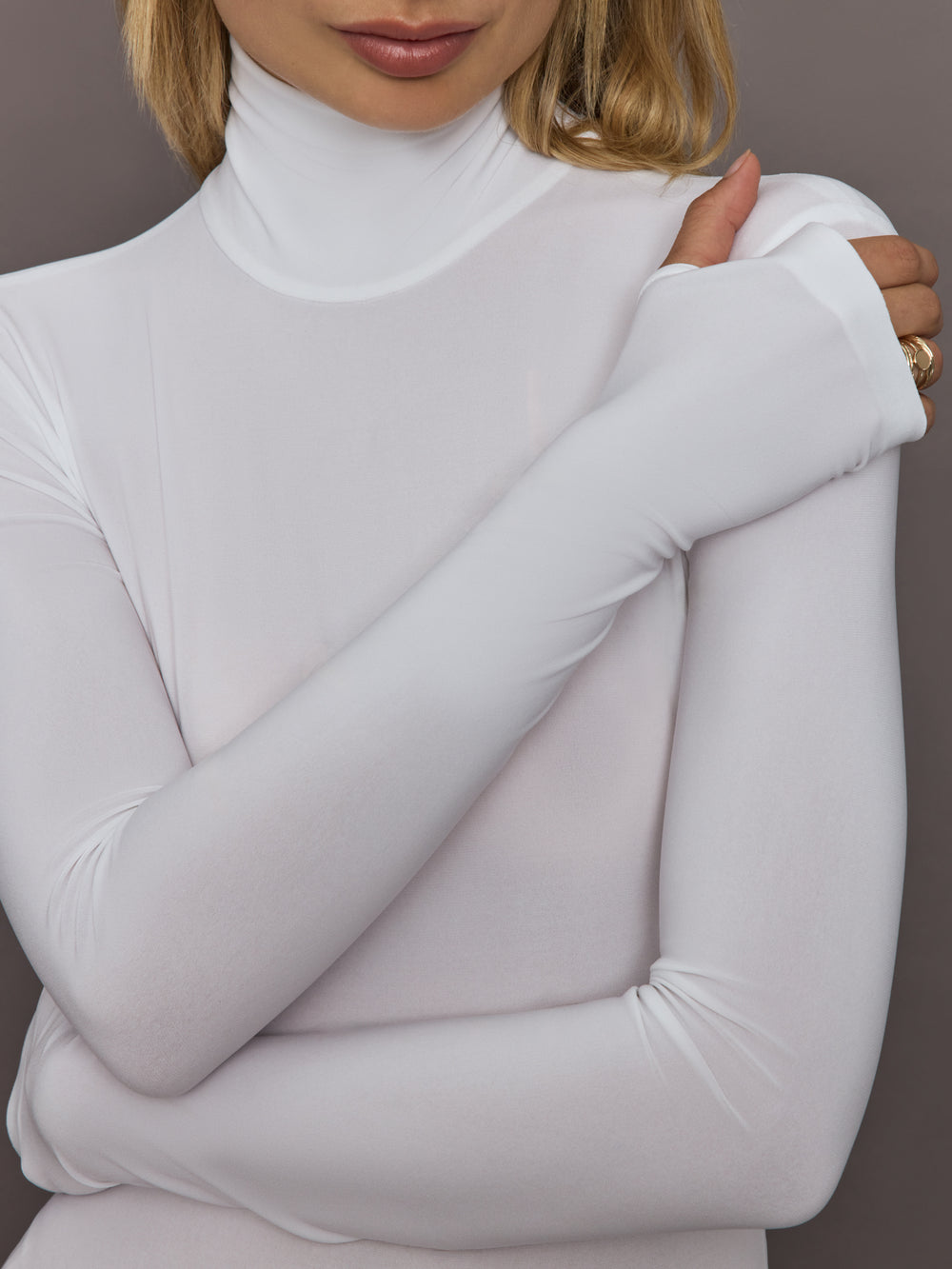 Close-up of Long Sleeve Turtle Bodysuit Snow White mock neck and sleeve detail.