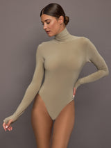 Model wearing a beige long-sleeve bodysuit.