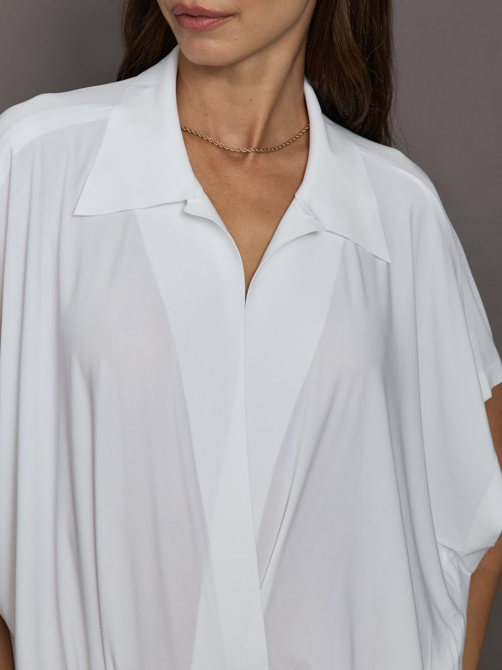 White shirt worn by a person with a neutral background