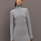 Model is wearing Long Sleeve Turtleneck Mini Dress in Grey, front view highlighting slim fit and high neckline.