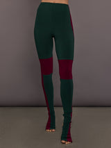 Model is wearing Side Stripe Legging With Knee Patch in Dark Emerald and Plum, front view showing knee patch placement.