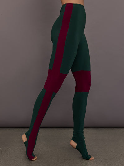 Model is wearing Side Stripe Legging With Knee Patch in Dark Emerald and Plum, side view with pointed toe and stripe detail.