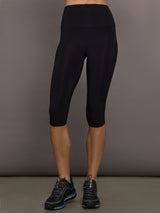 Model is wearing Pedal Pusher in Black, front cropped legging view.