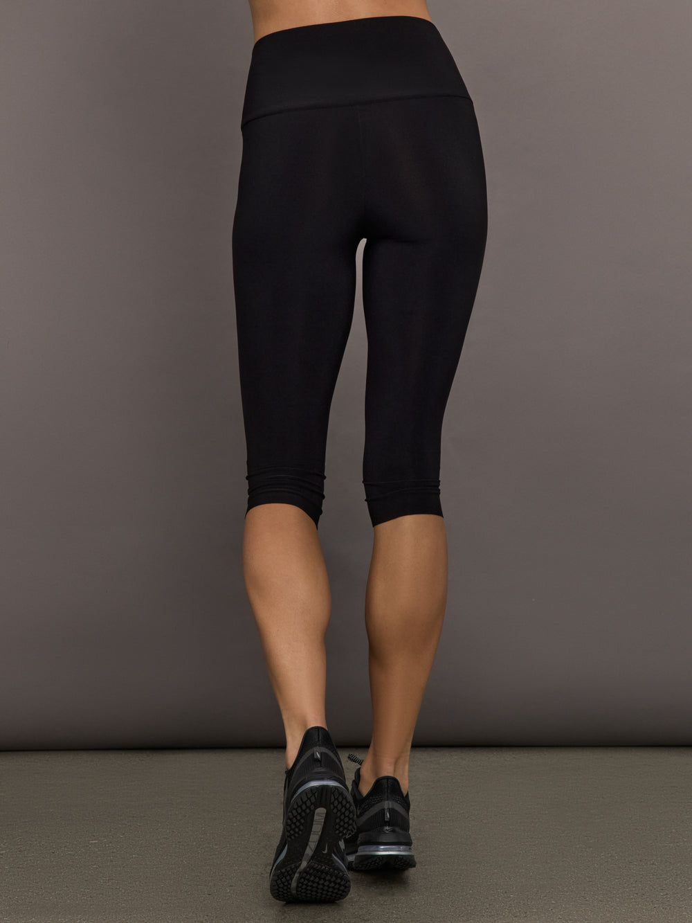 Model is wearing Pedal Pusher in Black, back waistband and length view.