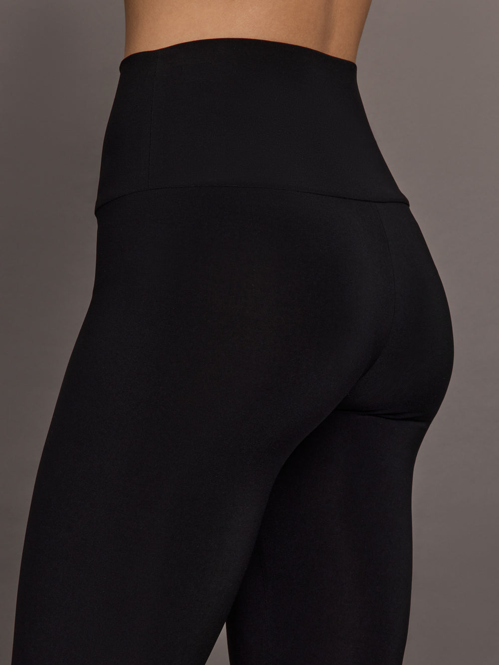Model is wearing Pedal Pusher in Black, close-up hip and fabric detail.