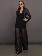 Model wears black single-breasted mesh jacket with a collared neck and tailored fit.
