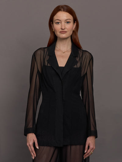 Model wears black single-breasted mesh jacket with a collared neck and tailored fit.




