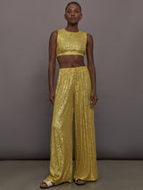 Model wears the Sleeveless Slim Fit Cropped Top in Asparagus, featuring a fitted, cropped, high neck design with sparkles.