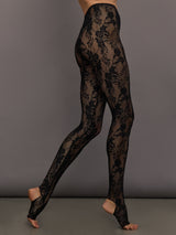 Black lace leggings worn by a model on a gray background
