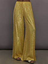 Model wears the Boyfriend Elephant Sweatpants in Asparagus, featuring a relaxed, tapered fit with oversized legs and sparkles.