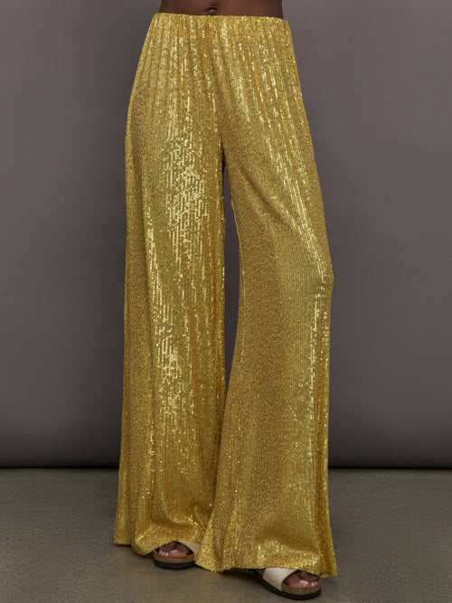 Model wears the Boyfriend Elephant Sweatpants in Asparagus, featuring a relaxed, tapered fit with oversized legs and sparkles.