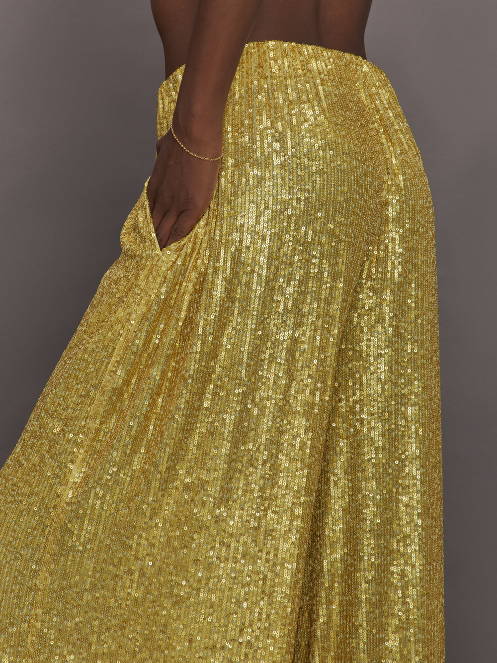 Model wears the Boyfriend Elephant Sweatpants in Asparagus, featuring a relaxed, tapered fit with oversized legs and sparkles.