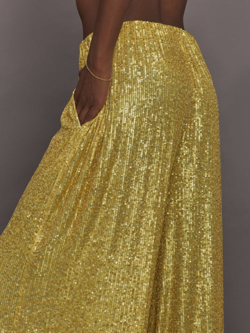 Model wears the Boyfriend Elephant Sweatpants in Asparagus, featuring a relaxed, tapered fit with oversized legs and sparkles.