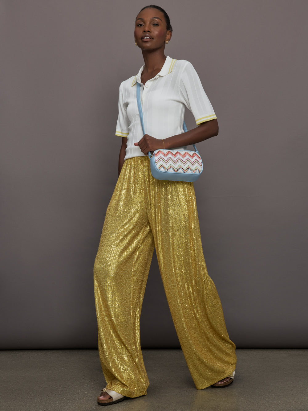 Model wears the Boyfriend Elephant Sweatpants in Asparagus, featuring a relaxed, tapered fit with oversized legs and sparkles.