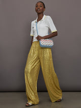 Model wears the Boyfriend Elephant Sweatpants in Asparagus, featuring a relaxed, tapered fit with oversized legs and sparkles.