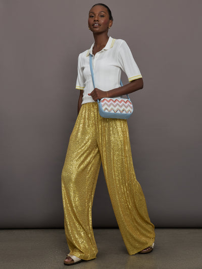 Model wears the Boyfriend Elephant Sweatpants in Asparagus, featuring a relaxed, tapered fit with oversized legs and sparkles.