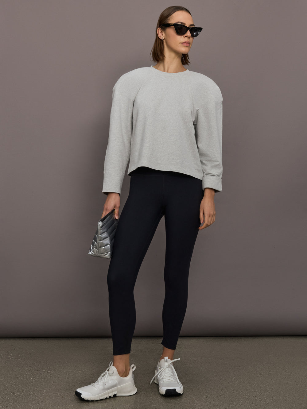 Model is wearing Bomber 1980s Sweatshirt in Light Heather Grey, full body styling.