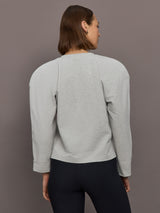 Model is wearing Bomber 1980s Sweatshirt in Light Heather Grey, back view.