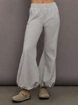 Model is wearing Boyfriend Puff Jog Pant in Light Heather Grey, front view.
