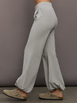 Model is wearing Boyfriend Puff Jog Pant in Light Heather Grey, side view.